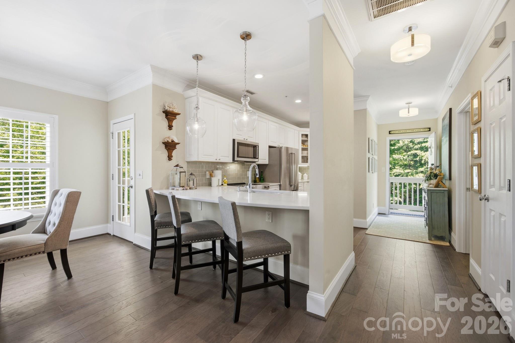 8942 Rosalyn Glen Road Cornelius, NC 28031 - Photo 10 of 47 a dining room with furniture and wooden floor
