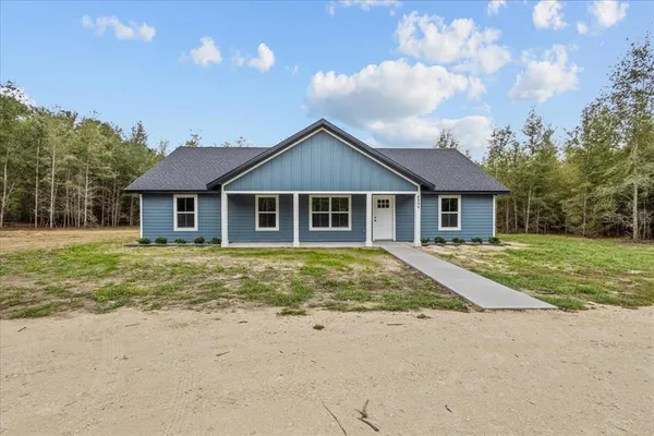 a house with trees in the background