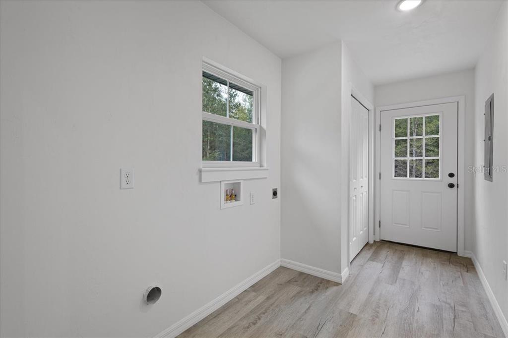 4899 Northwest 36th Street Bell, FL 32619 - Photo 11 of 67 an empty room with wooden floor and windows