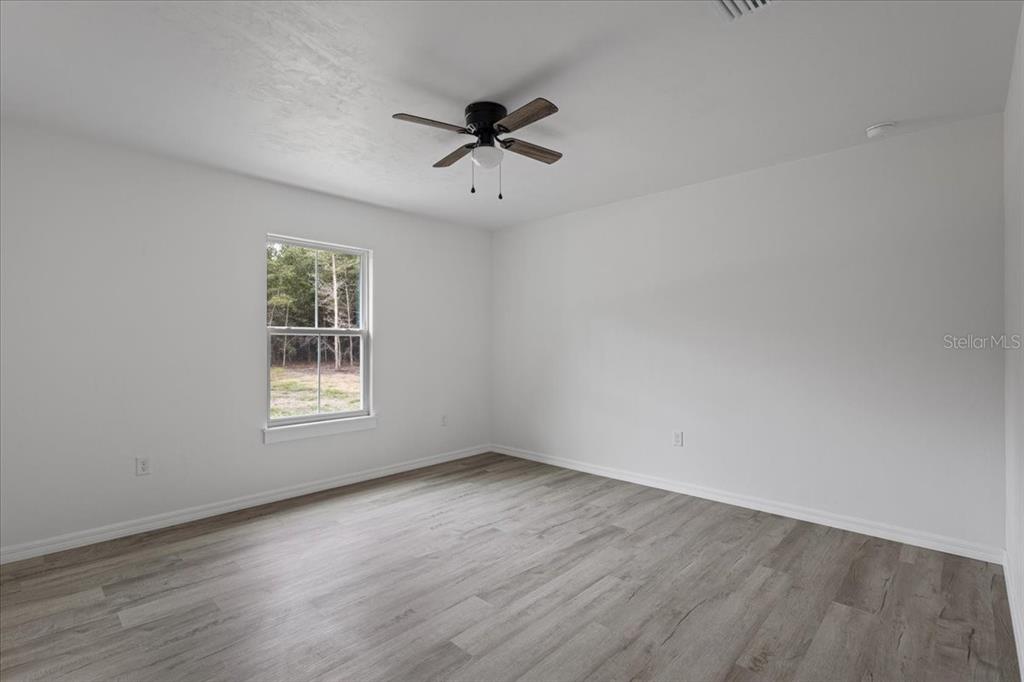 4899 Northwest 36th Street Bell, FL 32619 - Photo 23 of 67 wooden floor in an empty room with a window