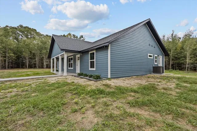 a view of a house with a backyard