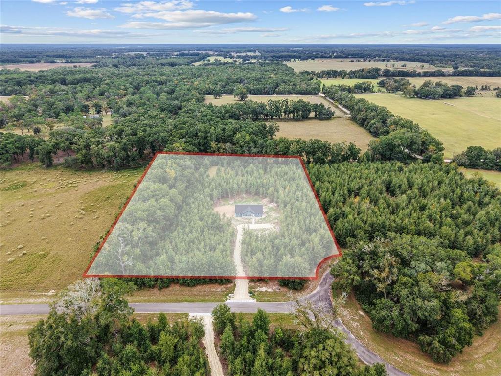 4899 Northwest 36th Street Bell, FL 32619 - Photo 31 of 67 an aerial view of a house with a yard and lake view
