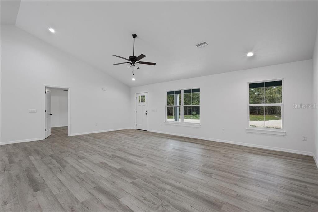 4899 Northwest 36th Street Bell, FL 32619 - Photo 8 of 67 a view of an empty room with a window and wooden floor