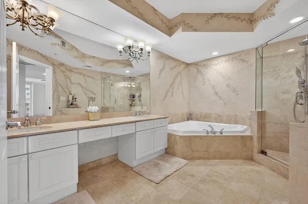 a bathroom with a double vanity sink mirror bathtub shower and toilet