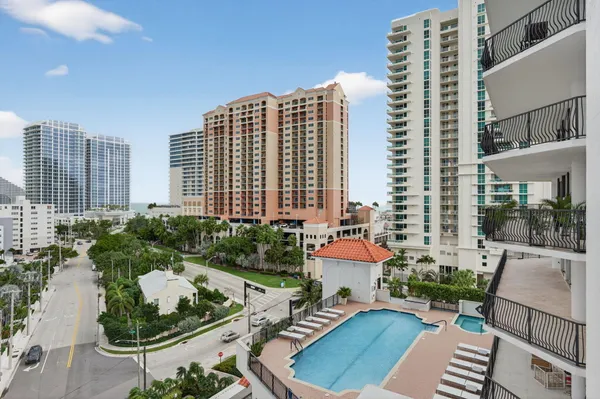 a view of a patio with couches table and chairs and potted plants
