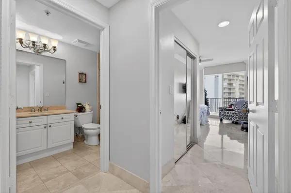 a bathroom with a granite countertop sink mirror and toilet