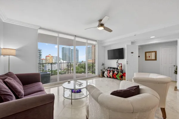 a living room with furniture and a flat screen tv with wooden floor