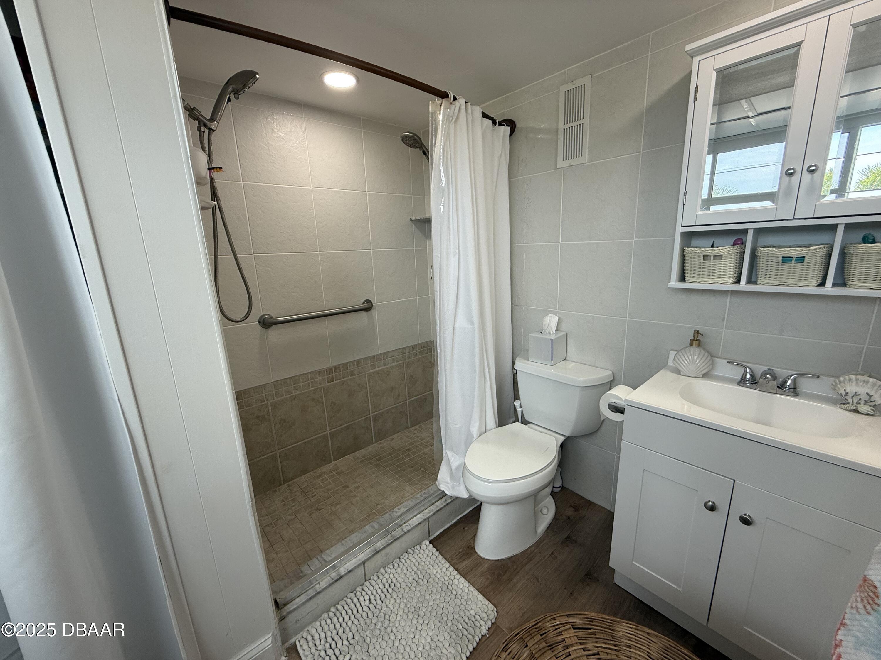 2711 North Halifax Avenue, Unit 288 Daytona Beach, FL 32118 - Photo 16 of 35 a bathroom with a sink toilet and shower