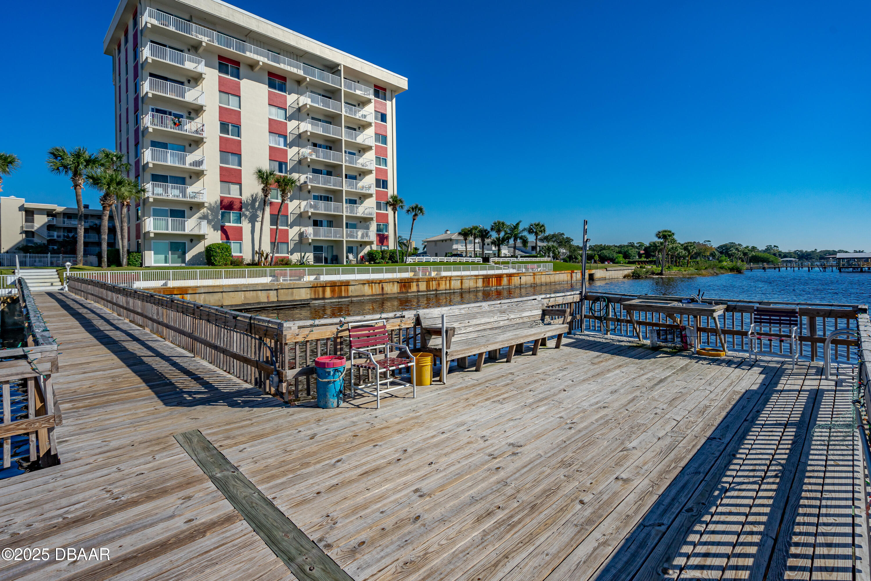 2711 North Halifax Avenue, Unit 288 Daytona Beach, FL 32118 - Photo 29 of 35 a view of roof deck with a barbeque and wooden stairs