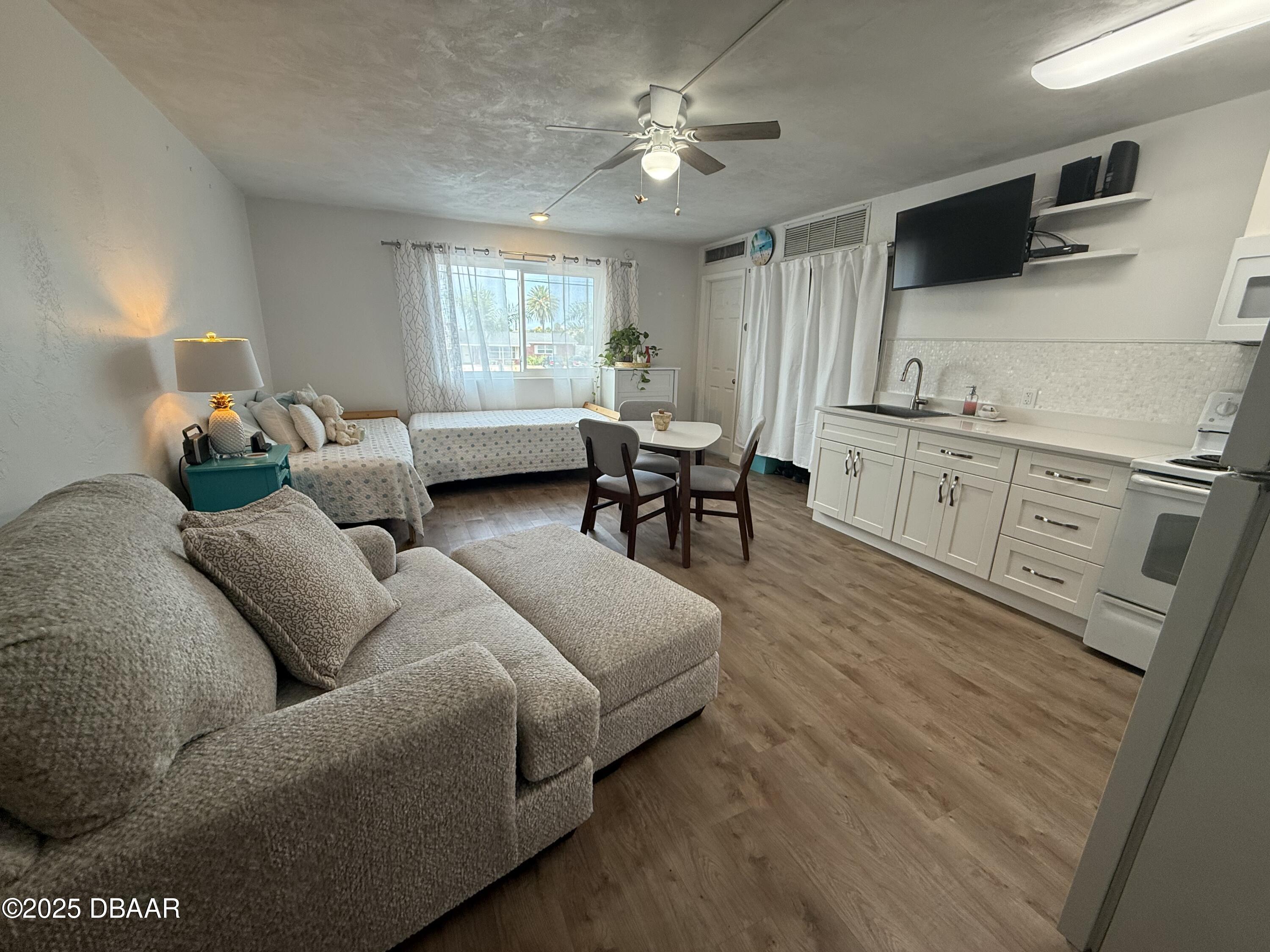 2711 North Halifax Avenue, Unit 288 Daytona Beach, FL 32118 - Photo 6 of 35 a living room with furniture and a window