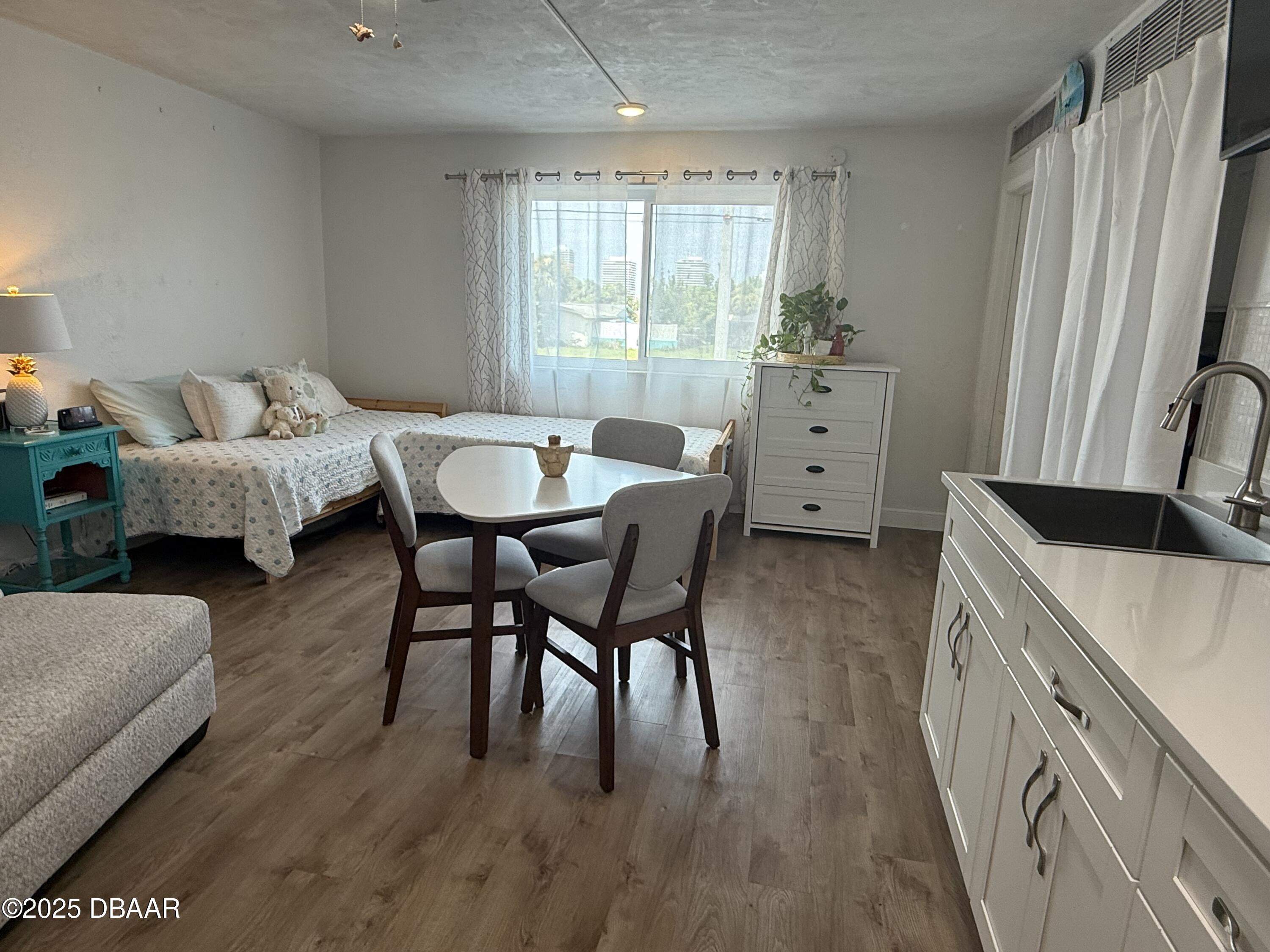 2711 North Halifax Avenue, Unit 288 Daytona Beach, FL 32118 - Photo 7 of 35 a living room with furniture and a large window