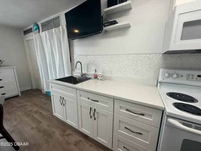 a living room with furniture and kitchen view