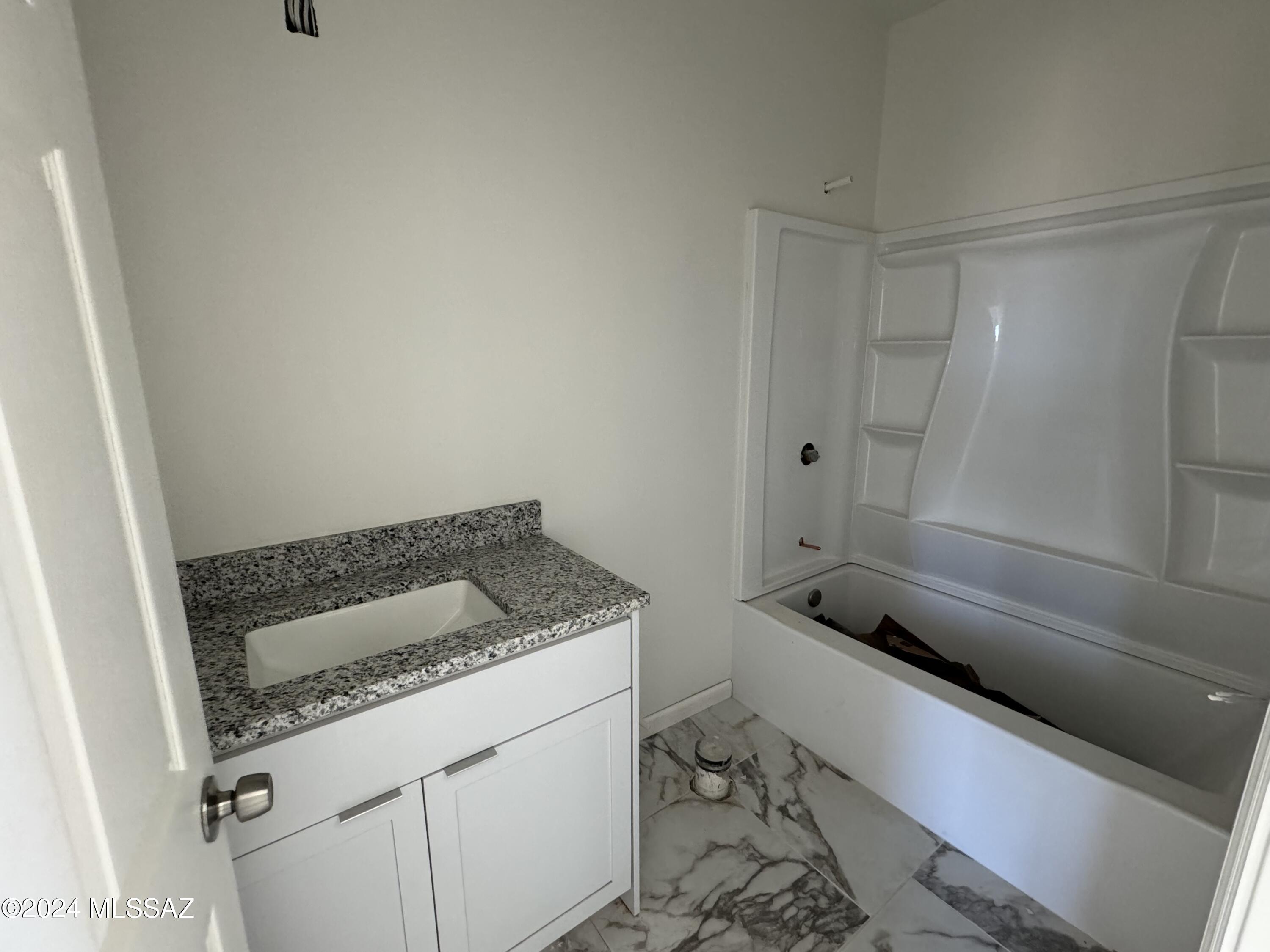 1643 Bala Court Rio Rico, AZ 85648 - Photo 10 of 18 a bathroom with a granite countertop sink and toilet