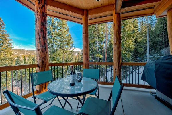 a view of a city from a dining room with large windows and furniture