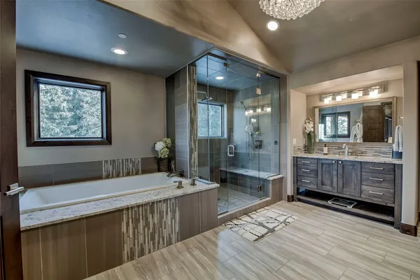 a bathroom with a double vanity sink a mirror and a shower