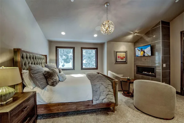 a bedroom with a bed window and a fireplace