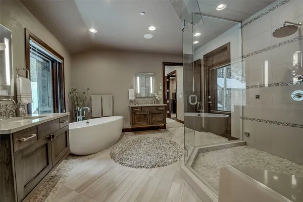 a large spacious bathroom with a large tub and sink