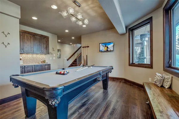 a view of a hallway view with wooden floor and living room