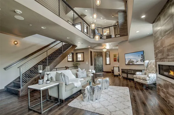 a living room with lots of furniture and kitchen view