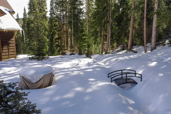 a vase of flowers sitting on a floor