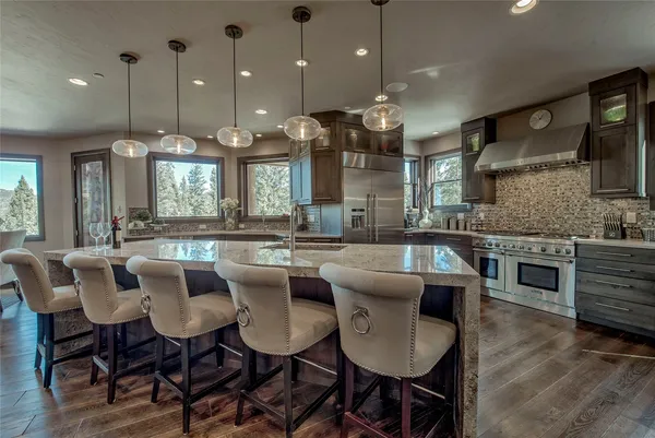 a large kitchen with a table and chairs