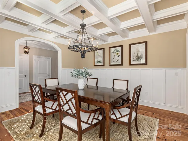 a view of a dining room with furniture and chandelier