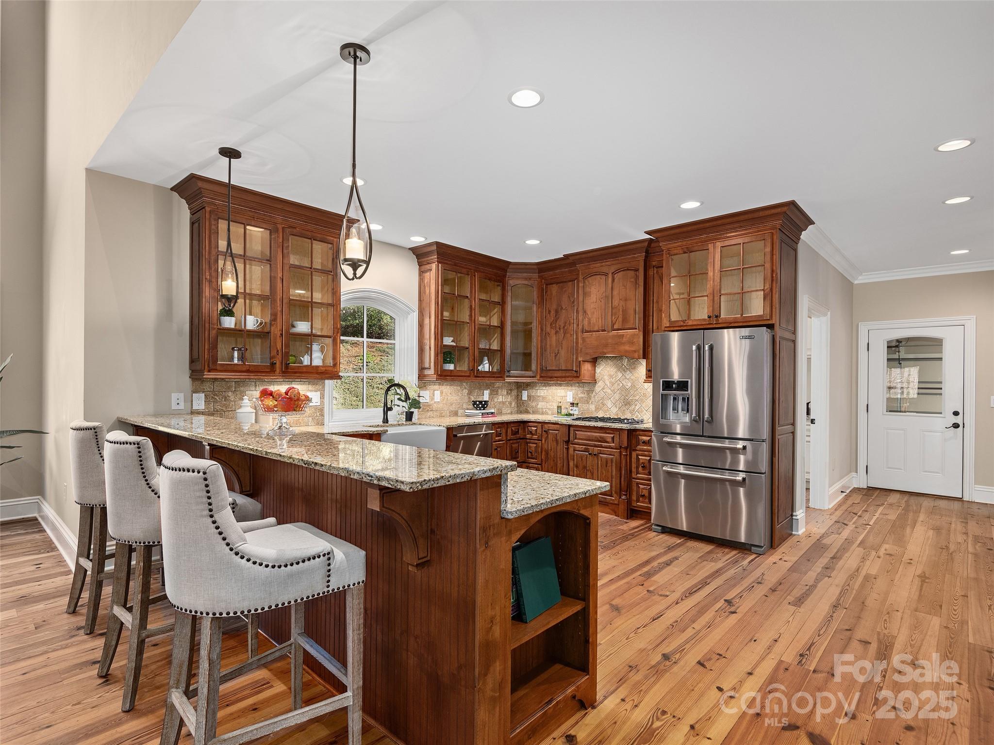 2514 Oakdale Road Old Fort, NC 28762 - Photo 12 of 48 a kitchen with refrigerator a sink and chairs