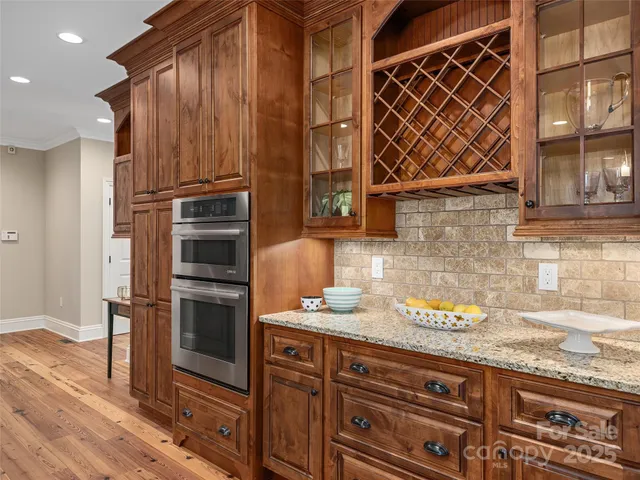 a kitchen with granite countertop wooden cabinets and stainless steel appliances