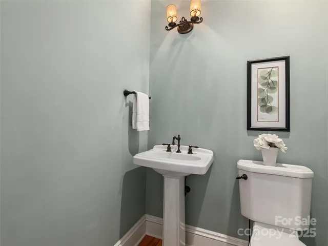 a bathroom with a sink toilet and a mirror