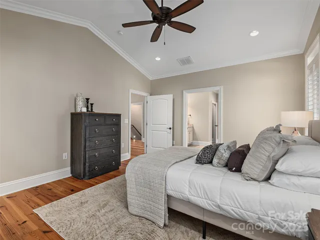 a bedroom with a bed and ceiling fan