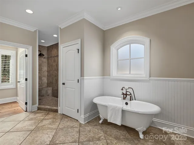 a spacious bathroom with a bathtub and shower