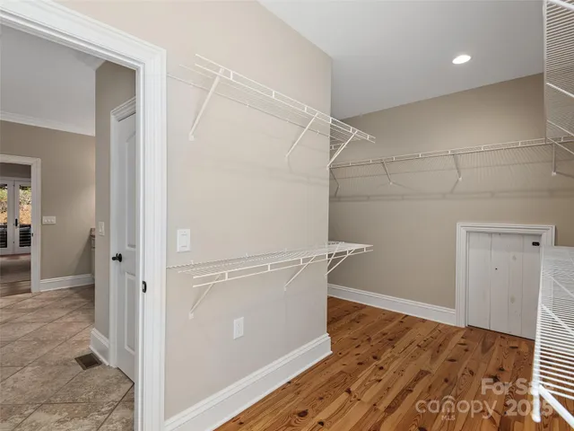 a view of a room with wooden floor
