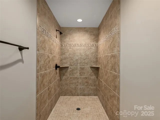 a view of empty room with windows and fireplace