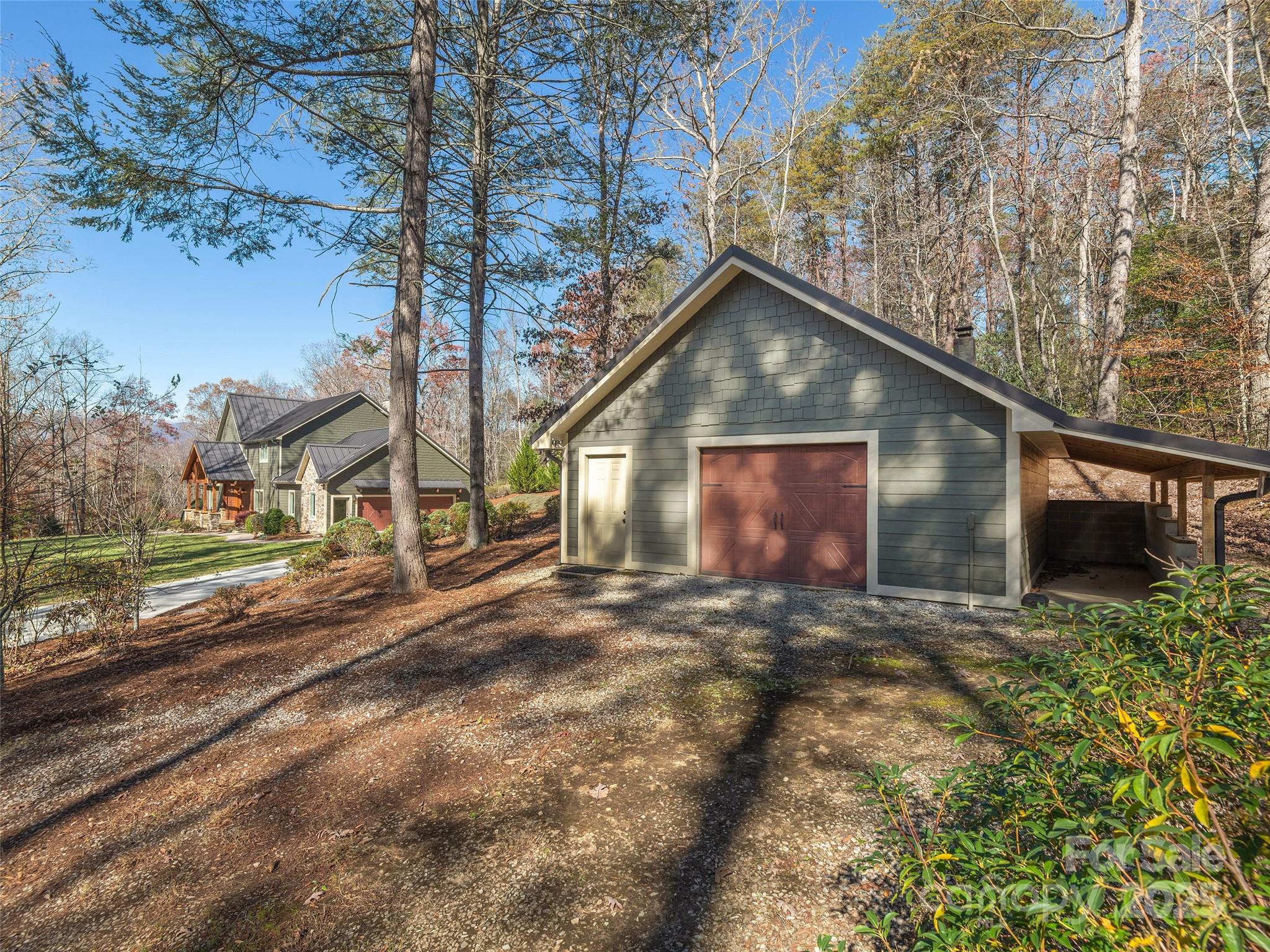 2514 Oakdale Road Old Fort, NC 28762 - Photo 42 of 48 a view of a house with a yard and garage