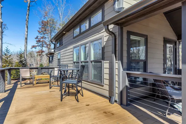 a porch with a bench next to a road