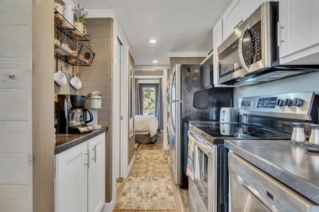 a kitchen with stainless steel appliances granite countertop a sink and cabinets