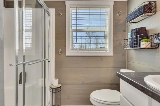 a bathroom with a toilet a sink and a shower