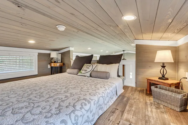 a bedroom with a large bed and a chandelier