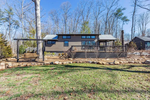 a view of a house with a yard and sitting area
