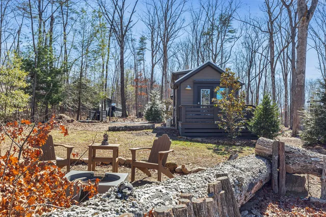 a view of a chairs and tables in the back yard of the house