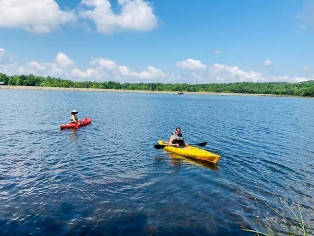 an aerial view of a house with a yard and lake view