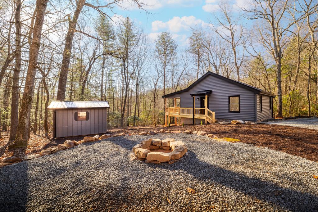 a backyard of a house with barbeque oven and outdoor seating