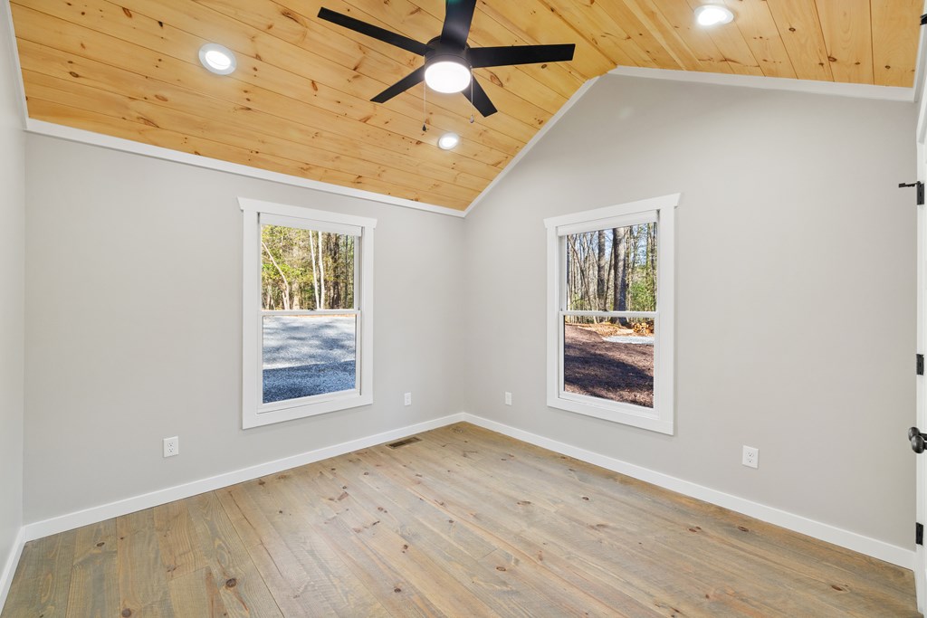 292 Wits End Way Cherry Log, GA 30522 - Photo 13 of 32 an empty room with wooden floor chandelier and windows