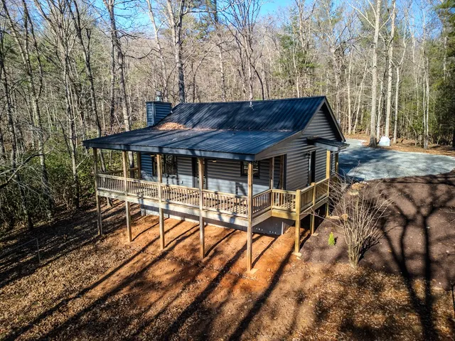 a view of a house with backyard porch and sitting area