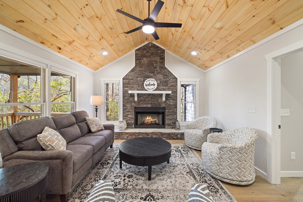 292 Wits End Way Cherry Log, GA 30522 - Photo 5 of 32 a living room with furniture a fireplace and a chandelier