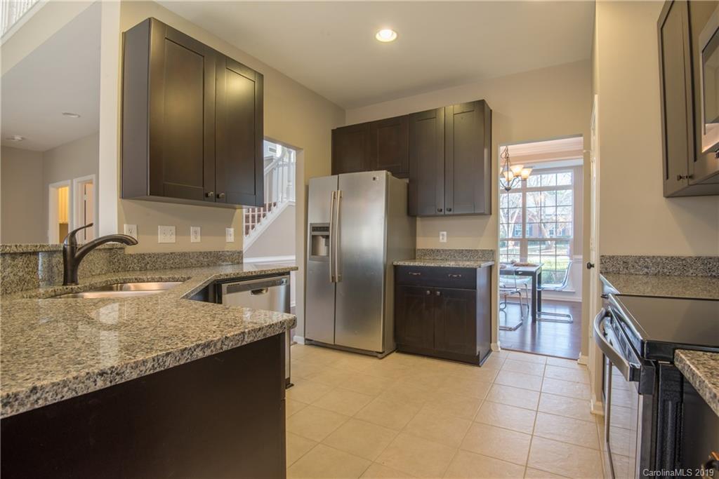 11712 Kennon Ridge Lane Huntersville, NC 28078 - Photo 2 of 31 a kitchen with granite countertop a refrigerator and a sink