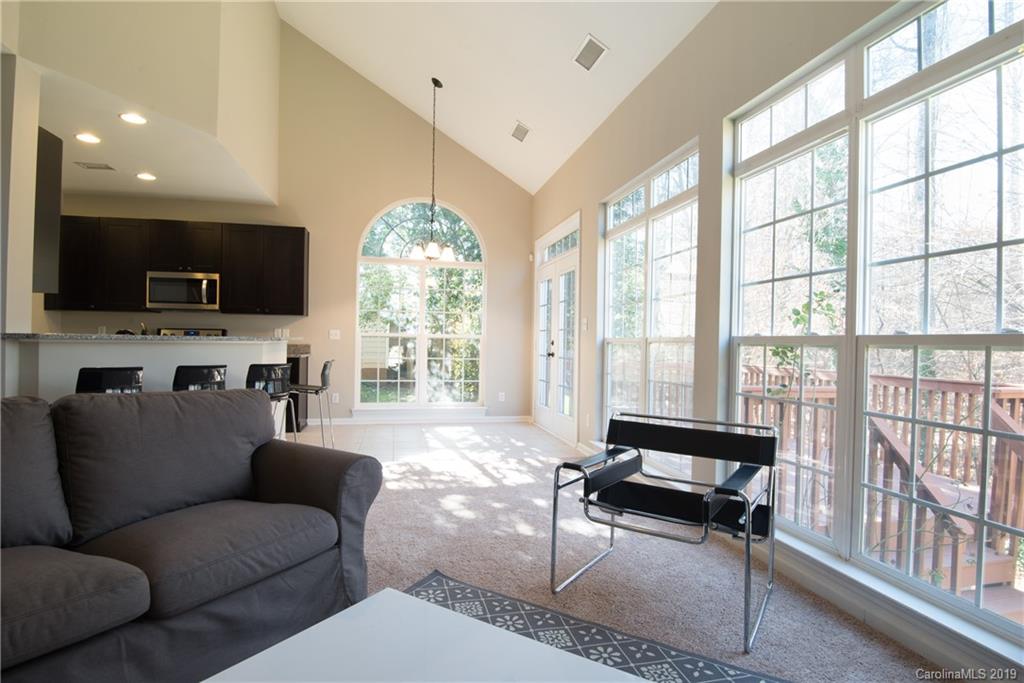 11712 Kennon Ridge Lane Huntersville, NC 28078 - Photo 11 of 31 a living room with furniture a flat screen tv and a large window