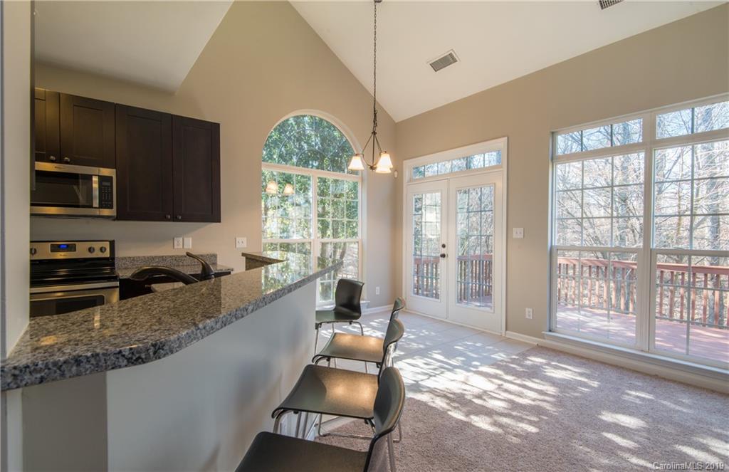 11712 Kennon Ridge Lane Huntersville, NC 28078 - Photo 14 of 31 a large kitchen with granite countertop a large window and stainless steel appliances