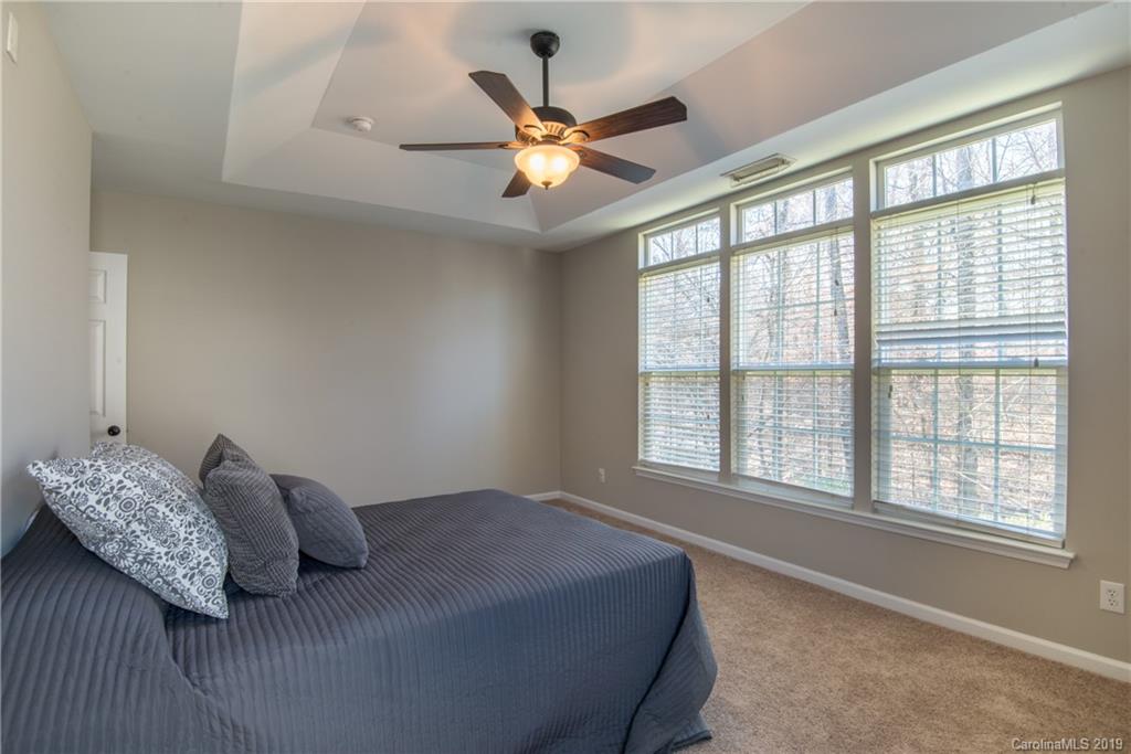 11712 Kennon Ridge Lane Huntersville, NC 28078 - Photo 18 of 31 a bedroom with a bed and a large window