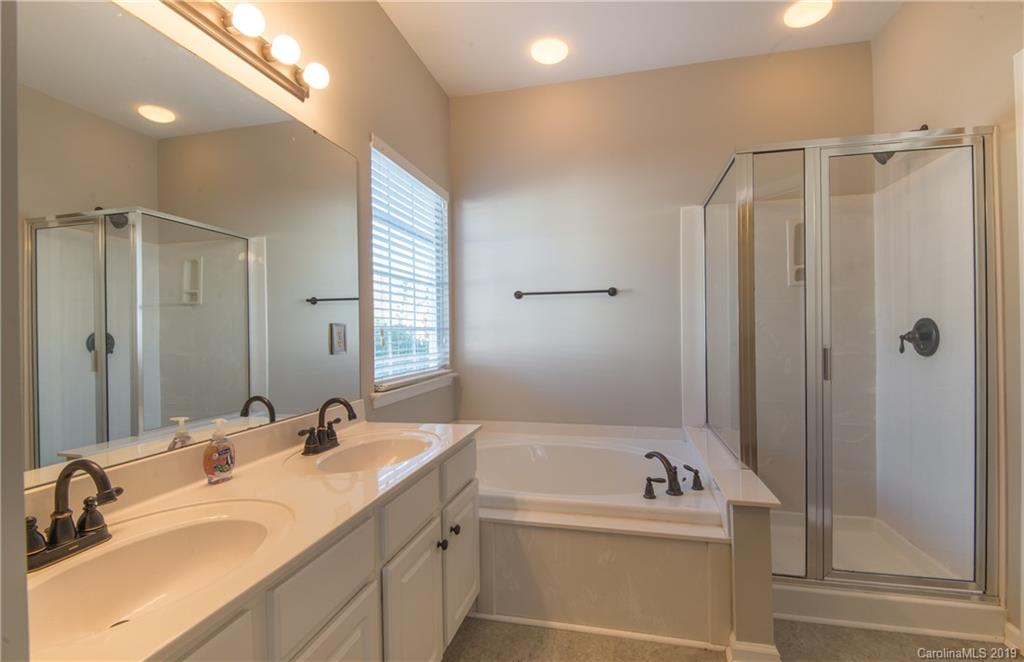 11712 Kennon Ridge Lane Huntersville, NC 28078 - Photo 19 of 31 a bathroom with a tub sink mirror and shower